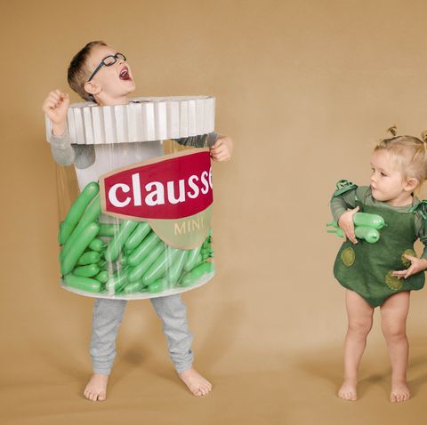 Image of 2 kids dressed as pickle jar and pickle for Halloween 