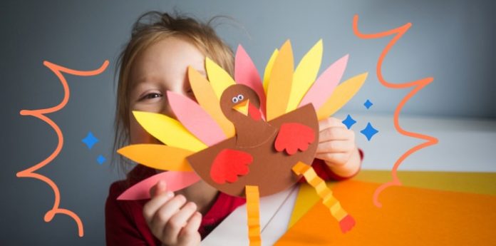 An image of a kid with crafts for thanksgiving