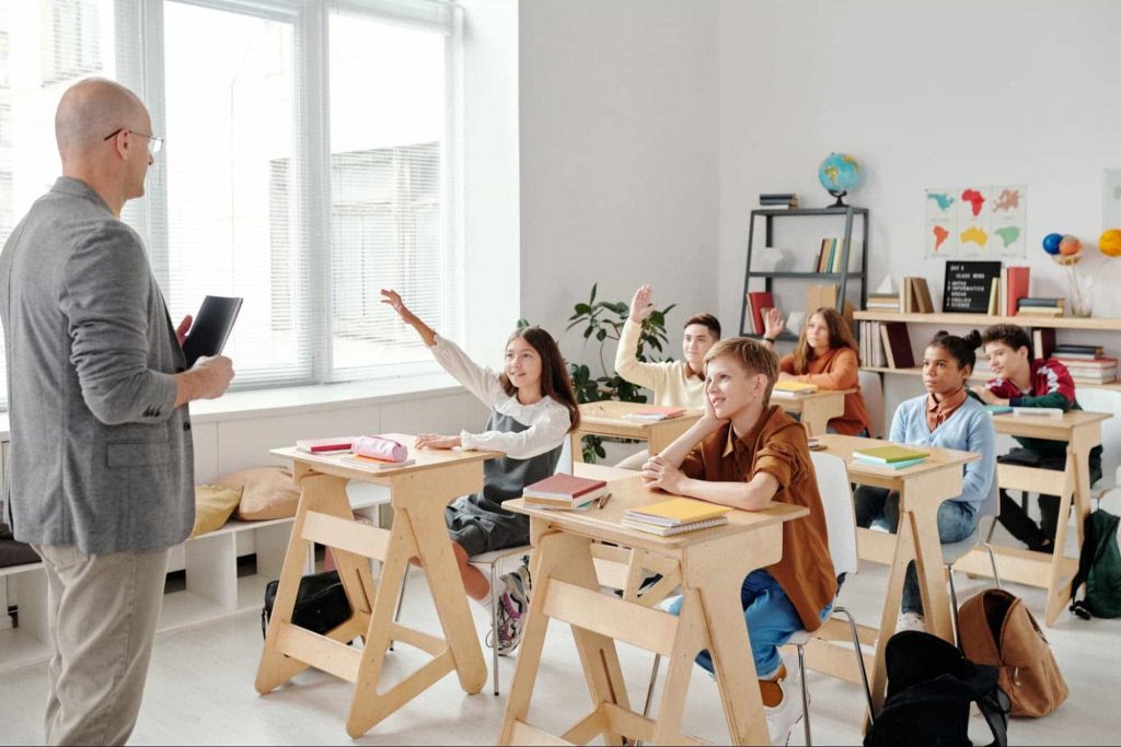 An image of a teacher teaching a class full of students