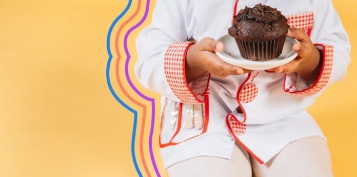 Image of a child holding a cupcake