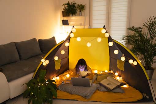 An image of a kid camping indoors indoor fun for kids