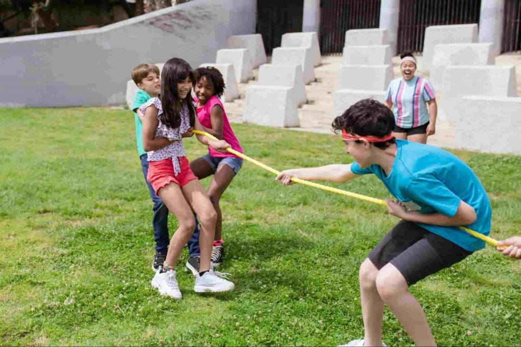 Image of kids playing tug of war - a fun outdoor activity for kids 