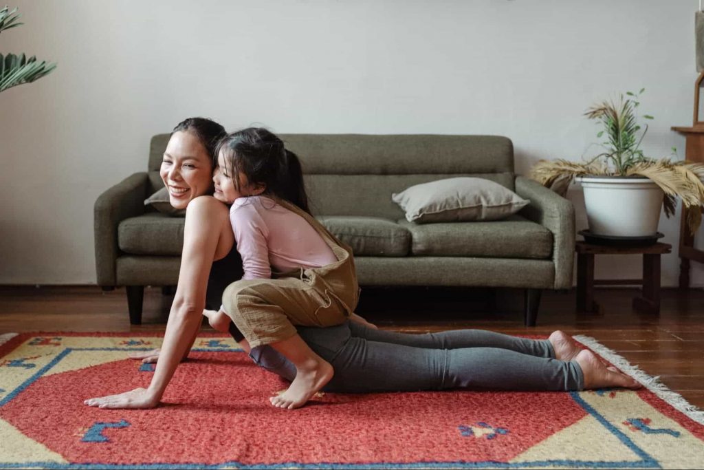Image of a mom & daughter doing yoga together 