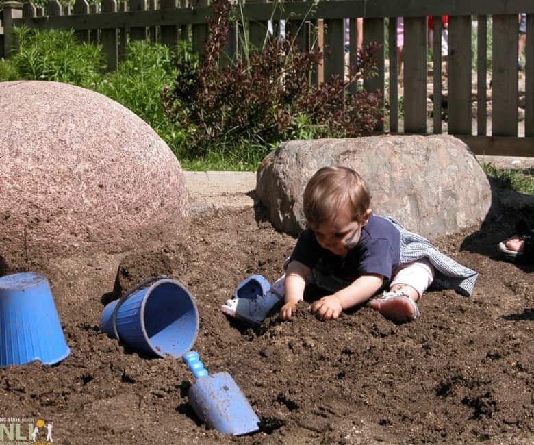 Image of a kid playing in dirt activities for preschoolers