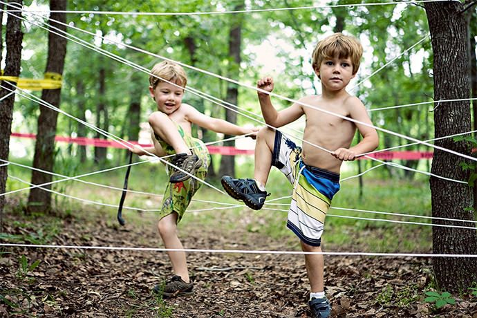 Image of kids playing mud hurdle run in the backyard