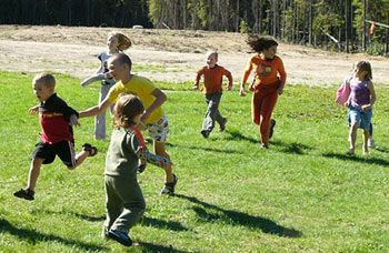 Image of kids running outdoors playing "catch me if you can"