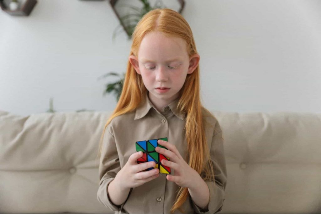 Image of a girl solving a cube