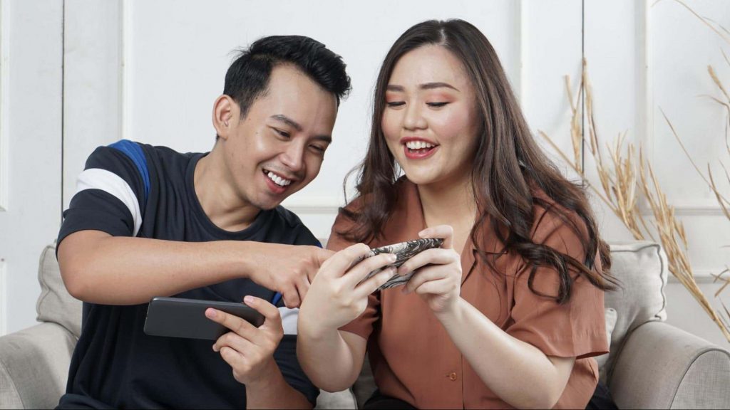 Man and woman playing games on phone