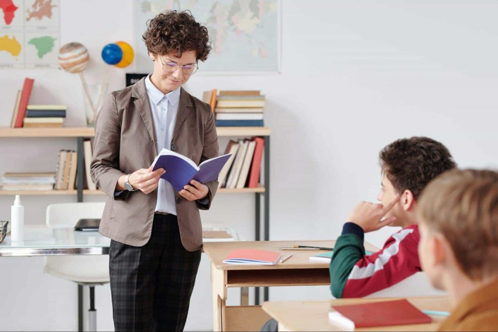 Image of teacher with book in hand 