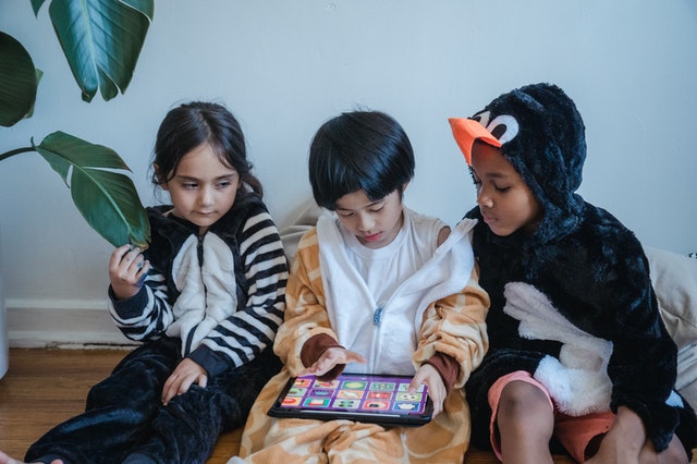 Children playing tablet game would you rather questions
