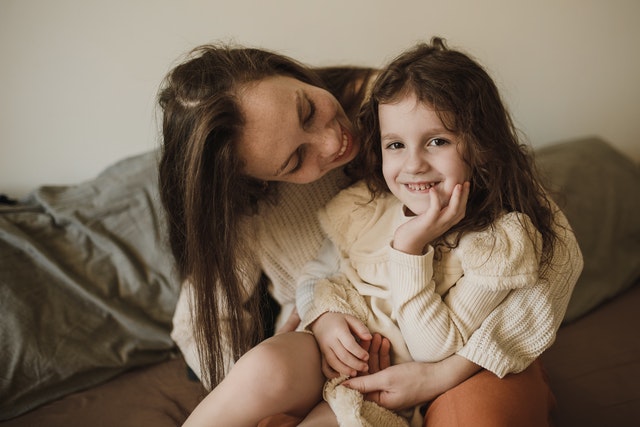 A happy mom and daughter parallel parenting