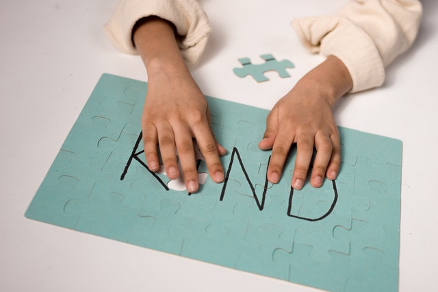 Childs hand on a puzzle dong puzzles for kids