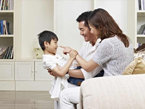 Parents playing with their child after reading short stories for kids