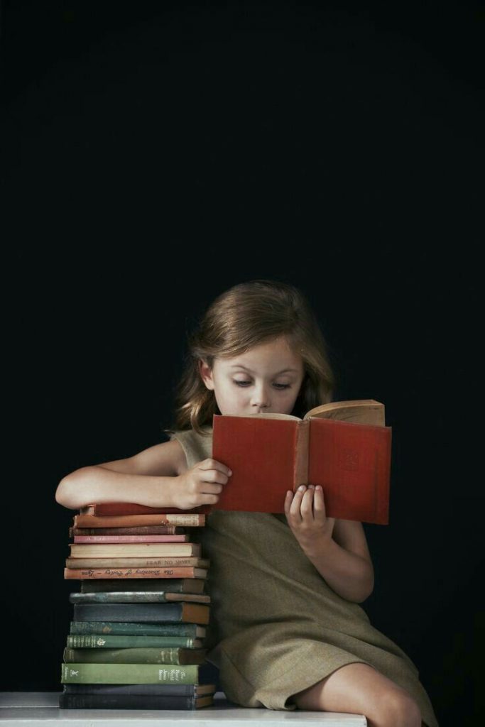 Little girl using reading strategy for novel Little girl using reading strategy for novel