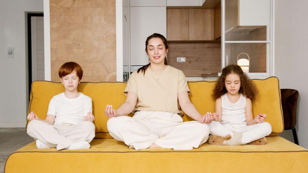 Mother meditating with children mindfulness for kids