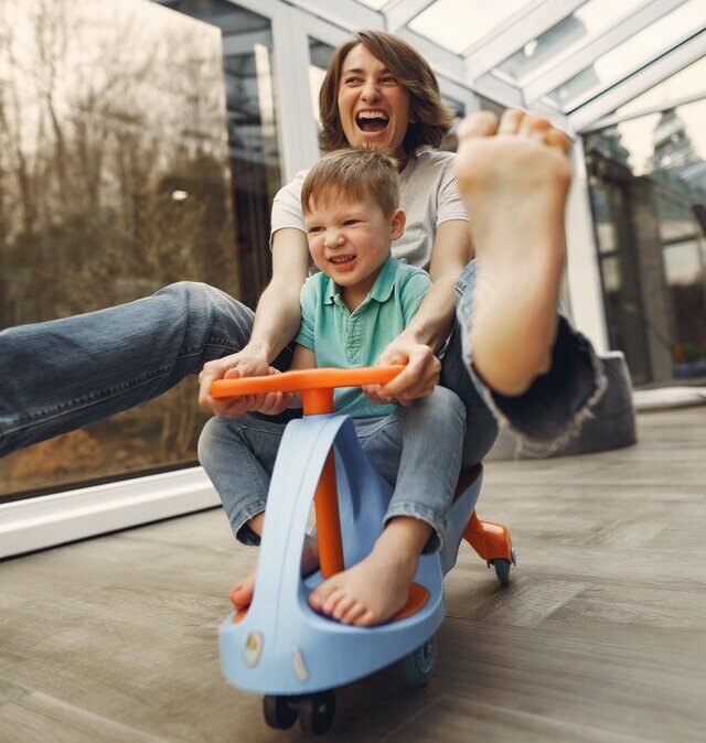 Mother on tricycle laughing having fun Party Games for kids