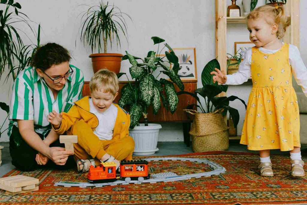 Mother playing with her child funny kids games with building blocks