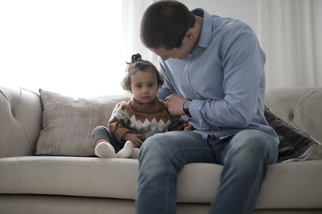 Photo of Man sitting beside his child Parallel Parenting Photo of Man sitting beside his child Parallel Parenting