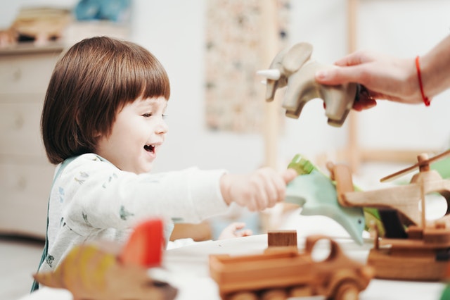 Small girl playing with toys Social Emotional Learning Activities