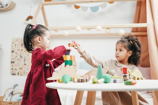 Small girls playing with blocks together compassionate vs empathetic Small girls playing with blocks together compassionate vs empathetic