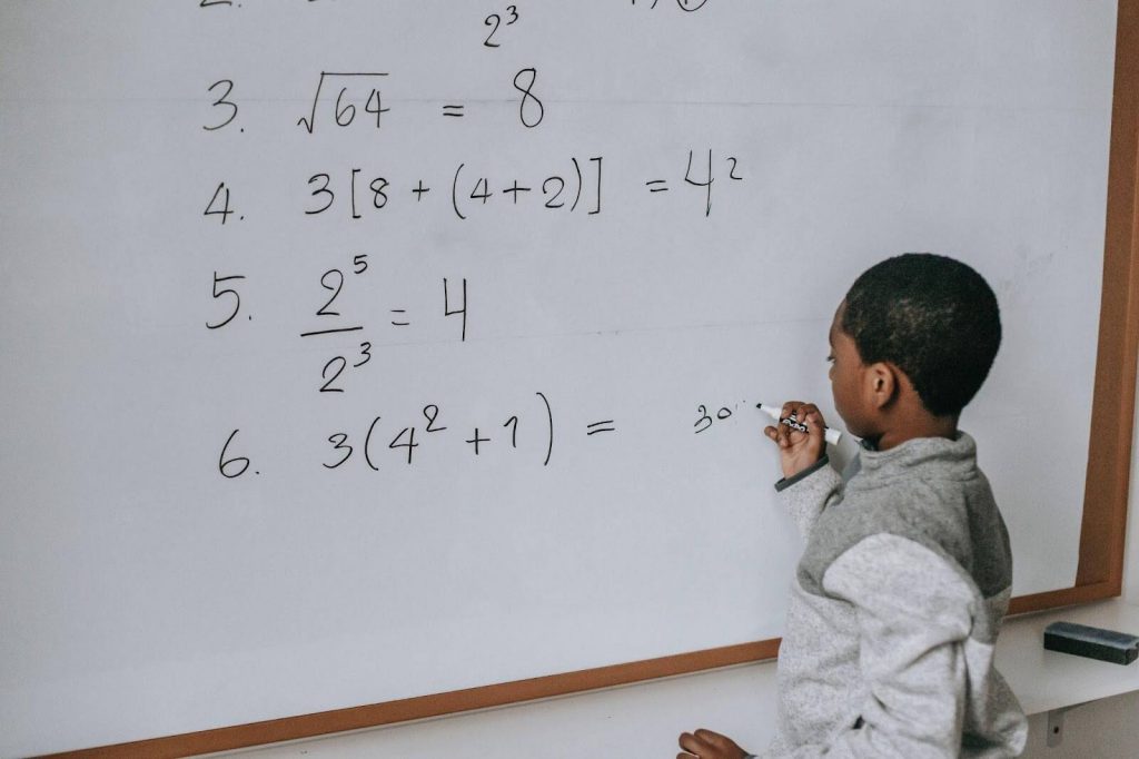 Students solving Math puzzles on board Students solving Math puzzles on board