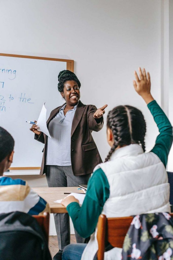 Teacher asking student to answer who is raising hand brain teasers for kids