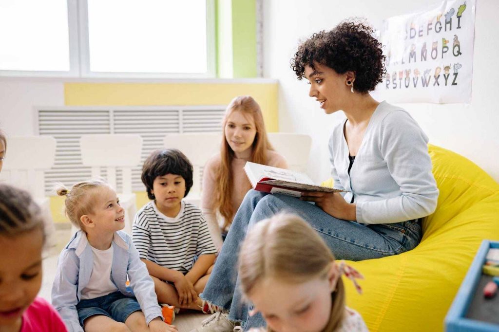 Teacher reading to students how to read a book