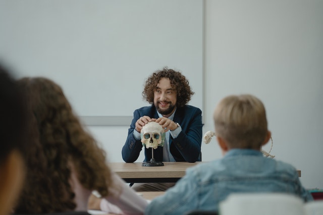Teacher talking to students abbout human skull why are educators important