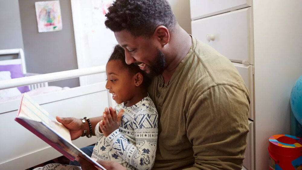 Image of father reading stories for kids