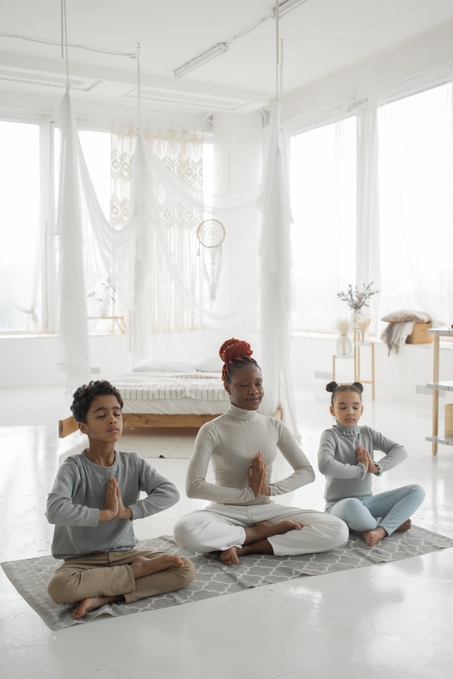 Woman meditating with children guided kids meditation