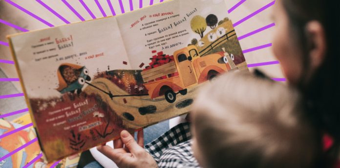 A close shot of story book mom and son reading camera shot on top