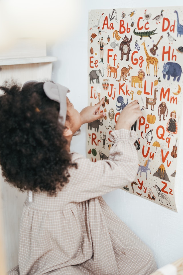Girl reading english alphabet phonological disorders Girl reading english alphabet phonological disorder
