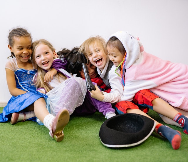 Group of children laughing together compassionate vs empathetic