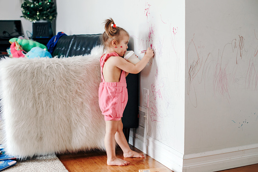 kidwritingonwall Image of a girl enjoying art summer activities for kids