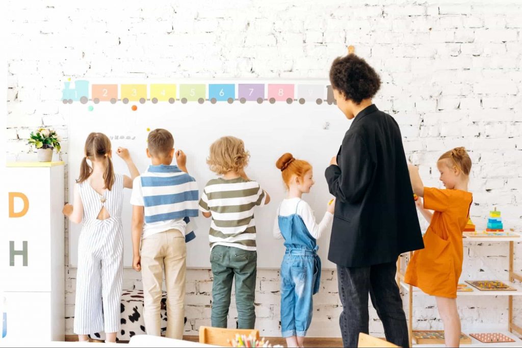 kidsandteacher Image of students and teacher doing a class activity