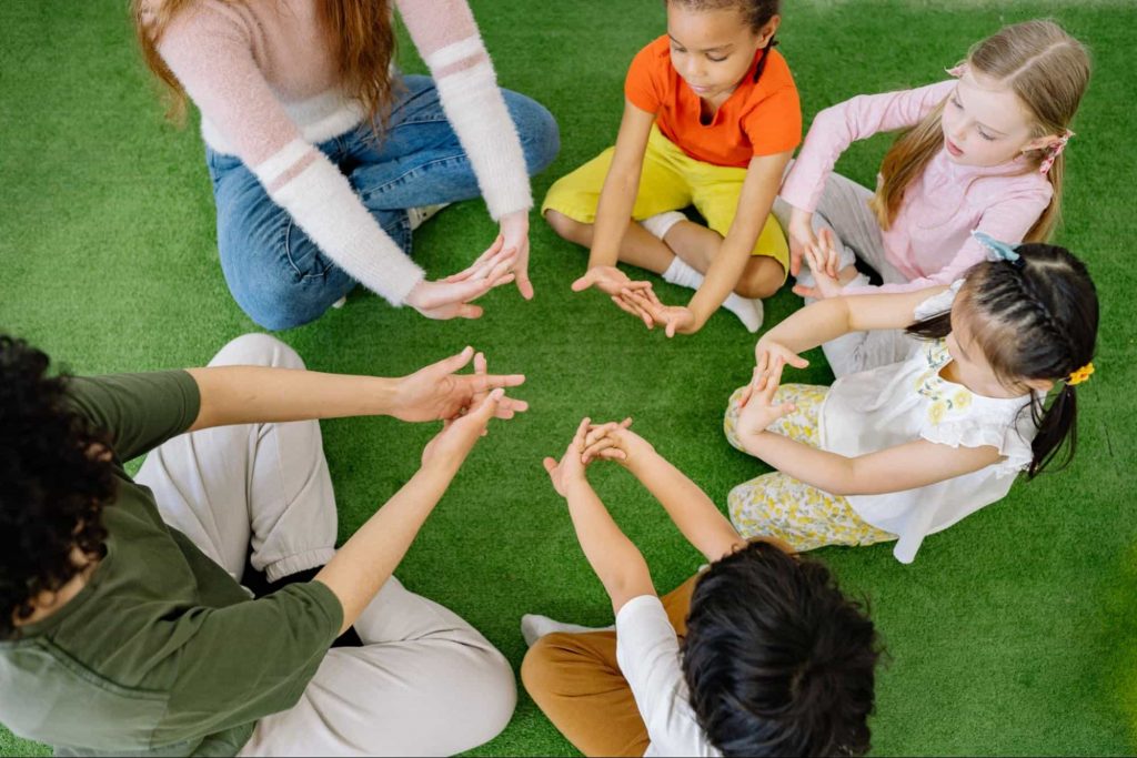 Image of a teacher trying to engage with students in a playground