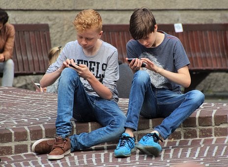 Image of kids playing games on phone