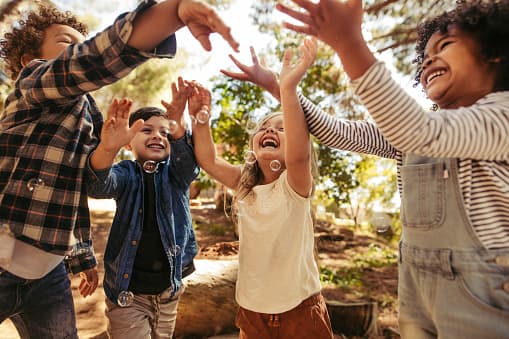 kidsplaying Image of kids enjoying outdoor summer activities for kids