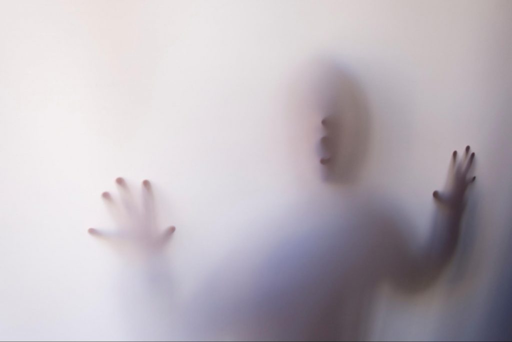 Image of a kid on a fog tainted glass