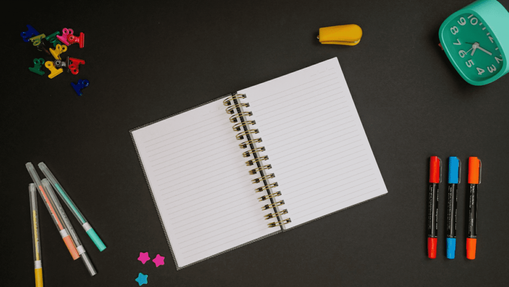 Image of notebook, pens, clock, sketches