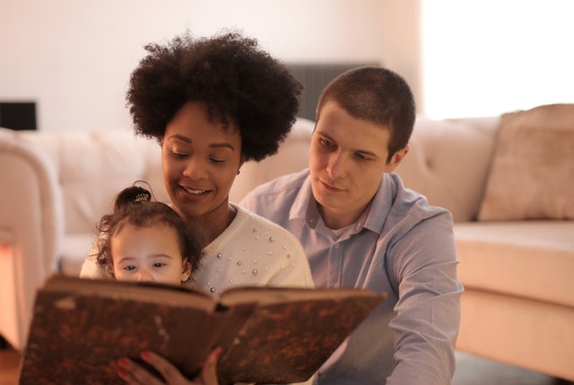 Parents reading to their child a bedtime story for kids