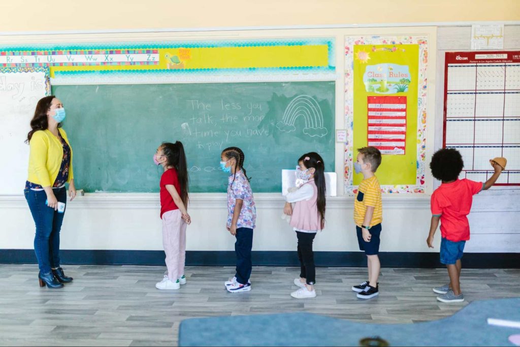 Image of students standing in a line in classroom - clasroom management styles 