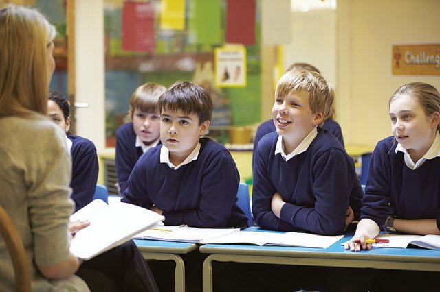 studentssmiling Image of students in school studying diligently with the learning experiences provided by the teacher