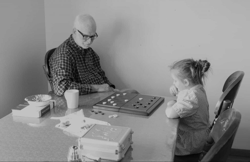 teacherandstudent | SplashLearn Image of a teacher and student playing a board game