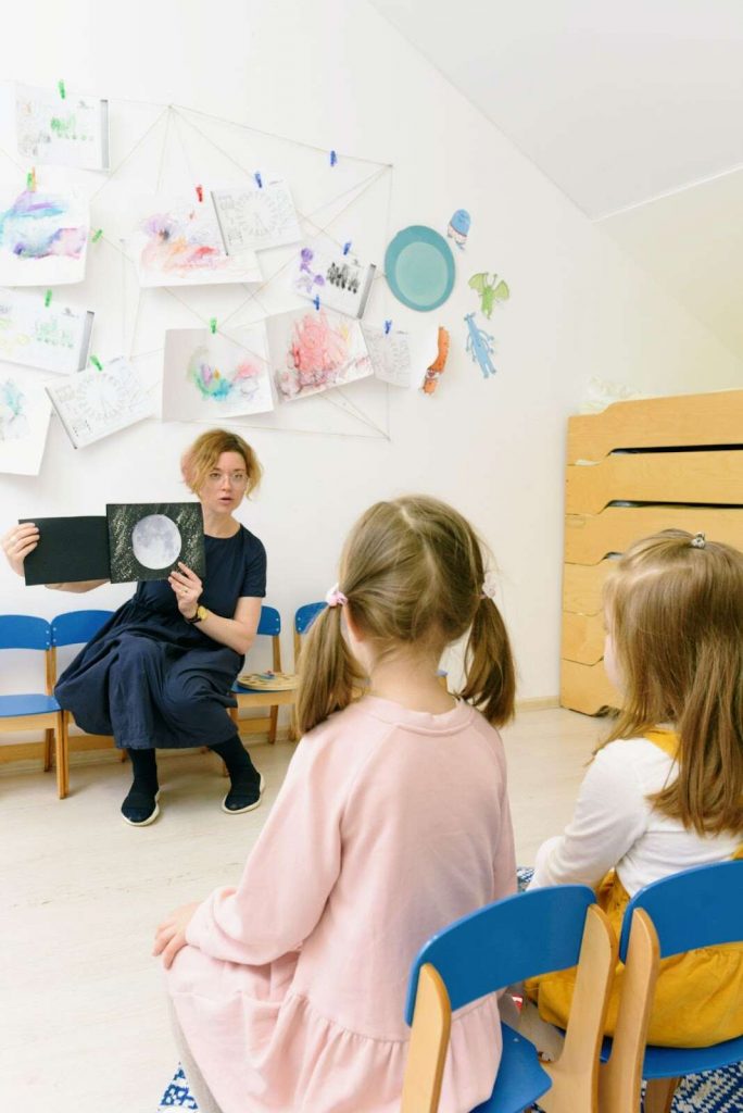 Teacher showing illustration of moon to students universal design for learning 4