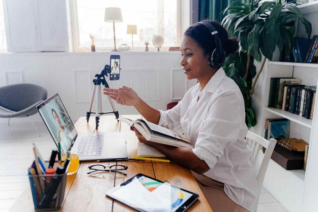 woman recording video on laptop webcam and mobile phone teaching tools woman recording video on laptop webcam and mobile phone teaching tools