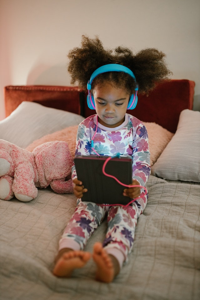 Young girl listening to tablet Auditory Learning