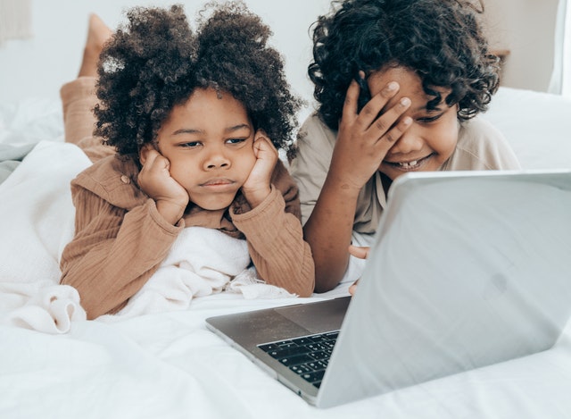 Young girls watching educational kids shows on laptop