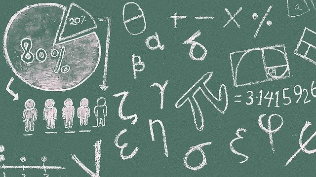 Blackboard with math symbols and graphs math symbols
