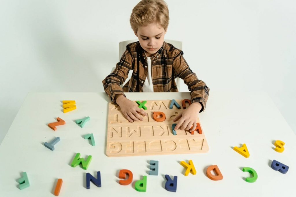 Child playing alphabet board game abc song for kids